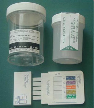 A set of medical supplies including a small plastic container with a white lid and a label on it. The container has a label that reads "SPLIT SPECTRUM" and "PEEL". Next to the container there is a small white card with a barcode and a bar graph on it which appears to be a test strip. The card is likely used to measure the accuracy of the test strip and provide information about the results. The background is a plain green surface.