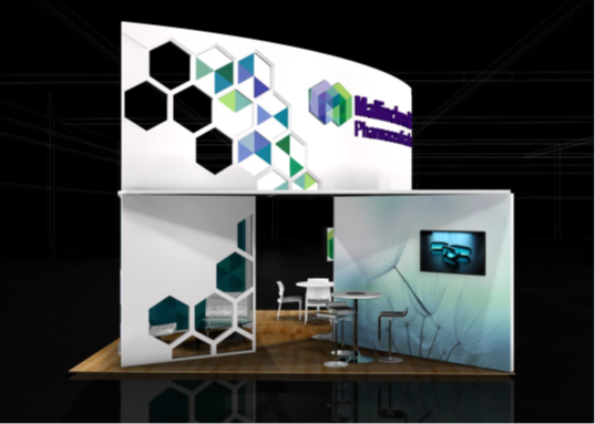 A trade show booth with a modern design. The booth is white with a curved roof and a large screen on the right side. The screen displays a colorful geometric pattern in shades of blue green and purple. On the left side of the booth there is a small table and two chairs and on the floor there are two stools. The background is black and the booth appears to be set up in a dark room with a high ceiling.