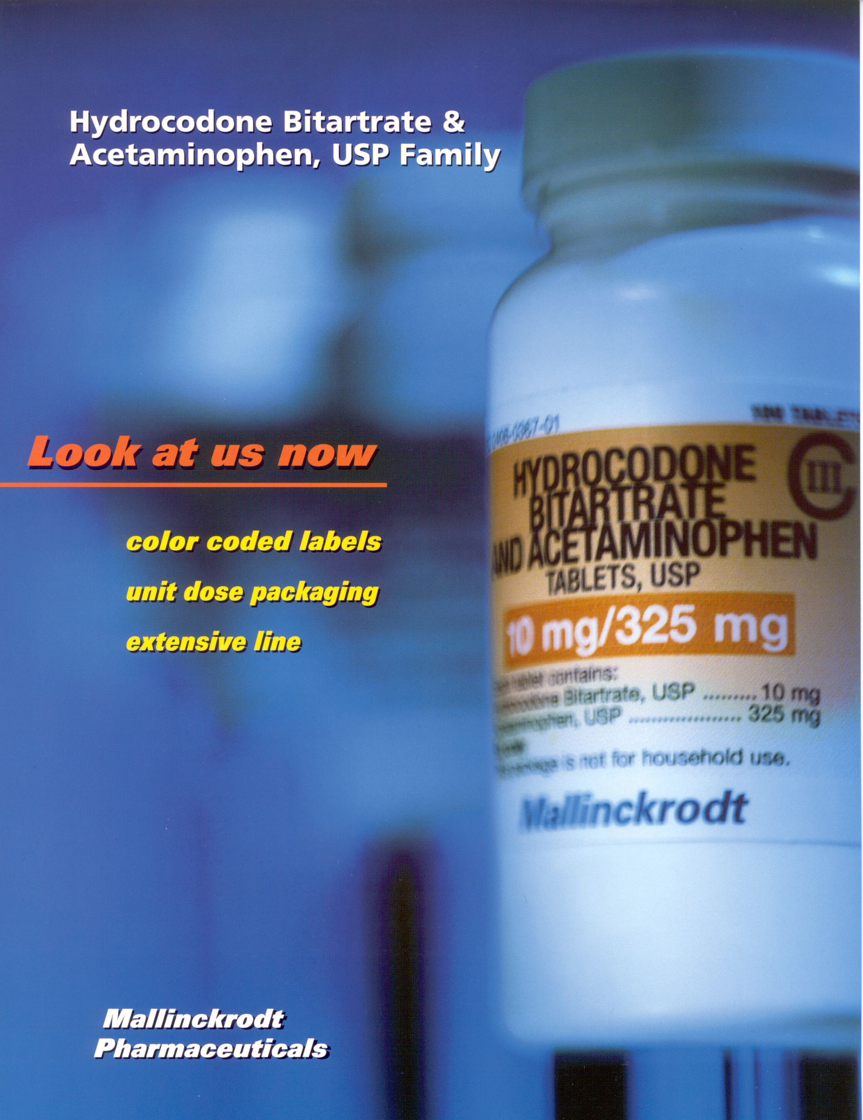 A close-up of a white medicine bottle with a label on it. The label reads "Hydrocodone Bitartrate & Acetaminophen USP Family" and "10 mg/325 mg". The bottle is from Mallinckrodt Pharmaceuticals and has a blue background. The text on the label is in orange and white and it appears to be an advertisement for the product. The bottle has a white cap and is placed on a blue surface.