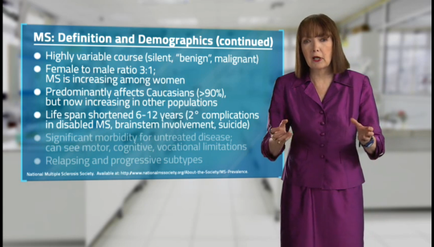 A woman in a purple suit standing in a hallway with a blue background. She is pointing to a slide with text that reads "MS: Definition and Demographics (continued)". The slide is titled "Highly variable course (silent benign malignant) Female to male ratio 3:1: Female is increasing among women. Predominantly affects Cucumbers (90%) but now increasing in other populations. Life span shortened 6-12 years (2-2 complications in disabled MS brainstorm involvement suicide) Significant morbidity for untreated disease can see motor cognitive vocal limitations relapsing and progressive subtypes." The woman appears to be giving a presentation or presentation.