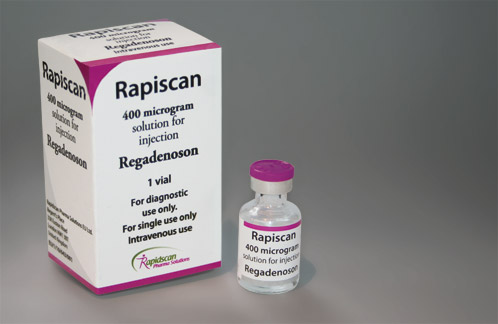 A white box with the brand name "Rapiscan" written on it. The box is rectangular in shape and has a pink and white color scheme. On the left side of the box there is a label that reads "400 microgram solution for injection Regadenoson". On the right side there are two small vials one with a purple cap and the other with a white cap. The vials are labeled "1 vial" and "For diagnostic use only". The label also mentions that the product is for single use only and that it is for intravenous use. The background is plain white.