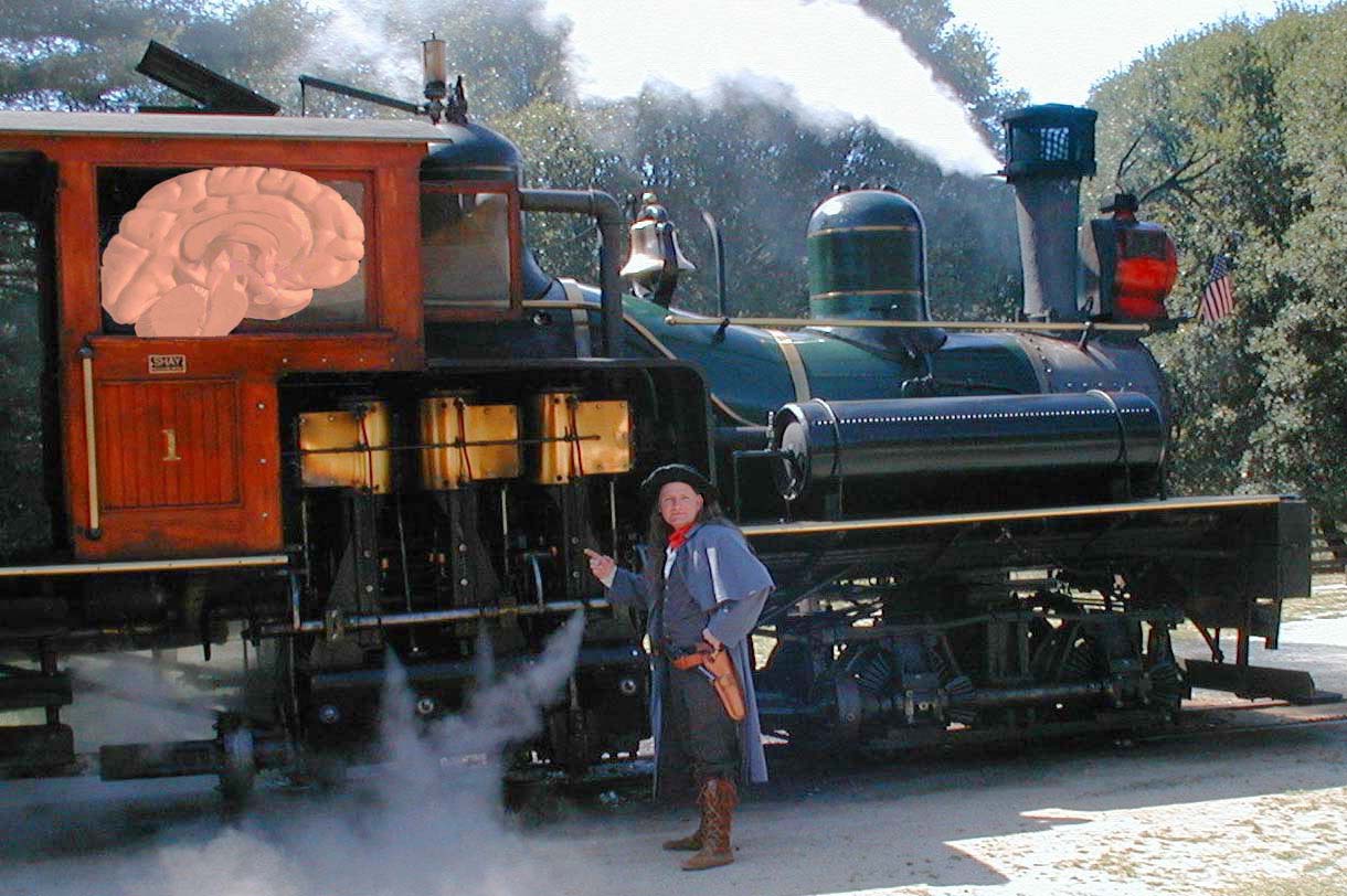 A man standing in front of a steam locomotive. The locomotive is black and green in color and has a large rose-shaped window on the side. The man is wearing a blue jacket brown pants and a black hat. He is holding a gun in his right hand and appears to be posing for the photo. There is smoke coming out of the locomotive and an American flag is visible on the right side of the image. In the background there are trees and a blue sky.