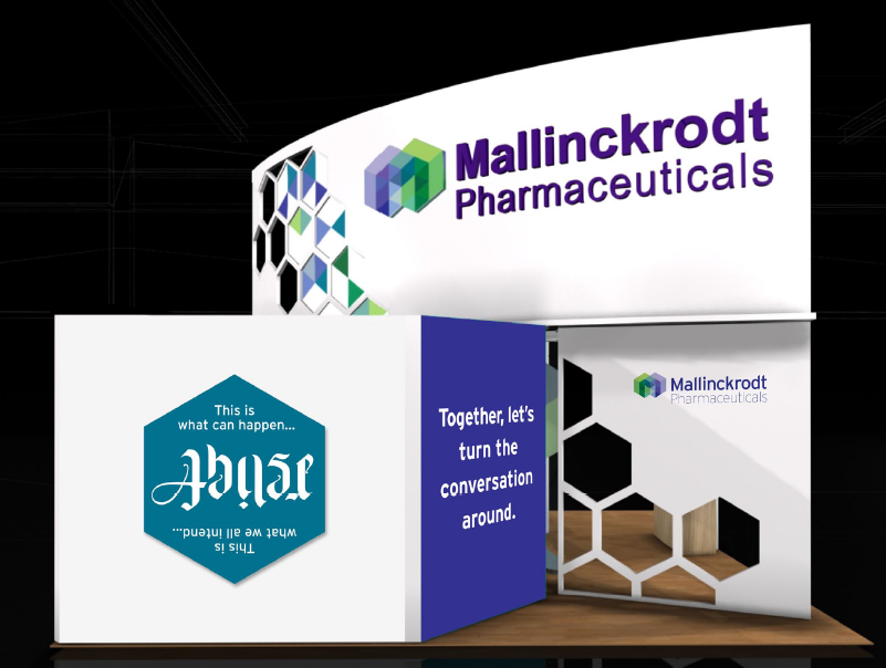 A trade show booth for Mallinckrodt Pharmaceuticals. The booth is white with a blue and green logo on the top left corner. The logo is a hexagon with the company name written in purple and green. On the right side of the booth there is a blue banner with the text "Together let's turn the conversation around." Below the banner there are two smaller banners with the same logo. The banners are placed on a wooden platform. The background is black.