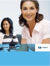 A cover page of a book titled "The Covidien Guide to Business Conduct". It features two young women sitting at a table smiling and looking at the camera. The woman on the right is wearing a white blouse and has shoulder-length dark hair. She is looking directly at the viewer with a slight smile on her face. On the left side of the image there is another woman with long dark hair wearing a black and white striped shirt. The background is blurred but it appears to be an office setting with a white wall and a window. The title of the book is written in blue text at the top of the page.