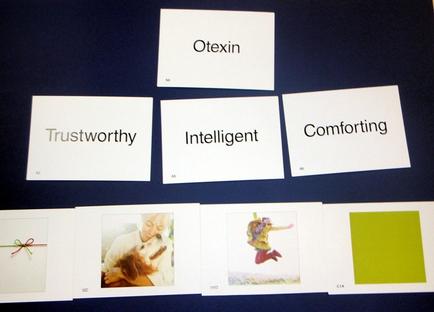 A set of six cards with the word "Otexin" written on them. The cards are arranged in a horizontal line on a dark blue background. The first card on the top left has the word written in white text. The word "Trustworthy" is written in a larger font size than the rest of the text. Below that there is a smaller text that reads "Intelligent" and "Comforting". The second card in the middle has a photo of a woman hugging a dog. The third card has a green square with a red ribbon tied around it. The fourth card has an image of a person jumping in the air with their arms outstretched. The fifth card has two images of the same woman hugging the dog. All the cards appear to be related to the concept of Otexin and its meaning.