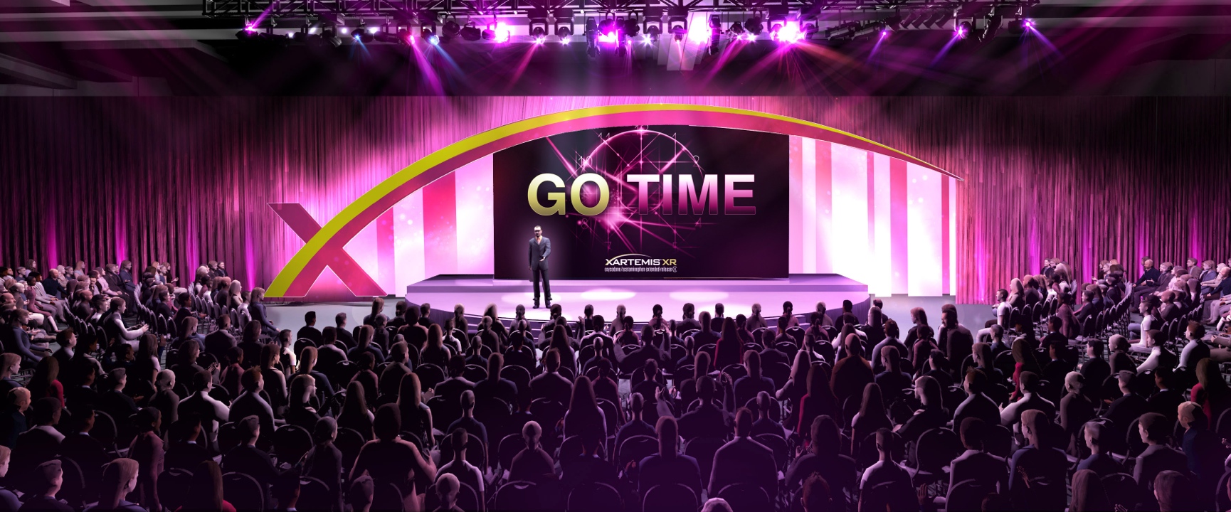 A large stage with a large screen in the center that reads "GO TIME". The stage is decorated with pink and purple lights and has a curved design. On the stage there is a man standing on a dais with a microphone in front of him. The audience is seated in rows of chairs facing the stage and attentively listening to the speaker. The overall atmosphere of the image is one of excitement and anticipation.