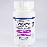 Of a white plastic bottle with a blue label. The label has the brand name "Percocet" written in bold black letters at the top followed by the product name "C" in smaller black letters. Below that there is a description of the product which states that it is 5 mg/325 mg and is a dietary supplement. The bottle has a white cap and is standing upright on a white background.