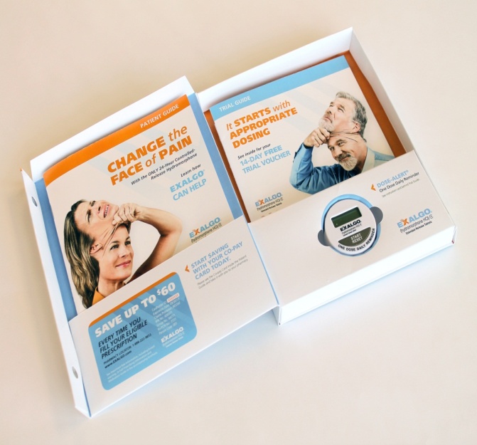 A white cardboard box with two pages inside. The left page has an orange background with a photo of a woman's face and text that reads "Change the face of pain". The right page has a blue background with an image of a man and a woman smiling and looking at each other. The text on the left page reads "Save up to $60". There is also a blue and white logo on the right side of the box. The box appears to be open revealing the contents inside.