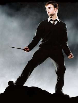 Harry Potter a young wizard standing on a rock with a wand in his right hand. He is wearing a black suit with a white shirt and a black tie. His hair is styled in a messy yet fashionable manner and he is wearing his iconic glasses. The background is dark and foggy creating a dramatic atmosphere. The overall mood of the image is intense and dramatic.