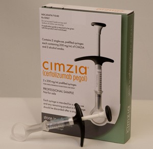 A professional sample of Cimzia (certifolizumab pegol) in its packaging box. The box is green and white in color and has the brand name written in bold black letters on the top left corner. On the right side of the box there is an image of the syringe with a black handle and a silver needle. The box "contains 2 pre-spilled syringes each containing 200 mg/ml of Cimzia".