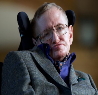 A close-up portrait of Stephen Hawking an English theoretical physicist cosmologist and author. He is sitting in a wheelchair with his head leaning to the right. Hawking is wearing a grey tweed blazer a french blue dress shirts a navy ascot (with red and white circles) and a pocket square. He has a serious expression on his face and is looking directly at the camera. The background is blurred but it appears to be an indoor setting with a wooden wall.