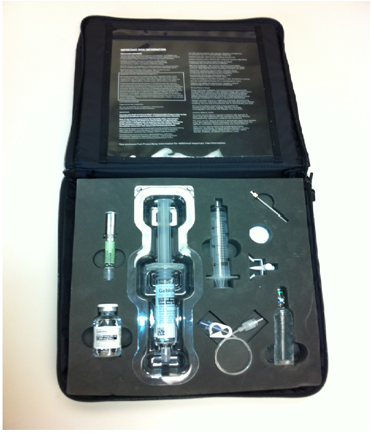 A black hard-shell case with a set of medical equipment inside. The case appears to be made of plastic and has a handle on the top for easy carrying. Inside the case there are various medical instruments including a syringe a needle a test tube and a small bottle. The syringe is open revealing the contents inside. There is also a label on the case with instructions on how to use the instruments. The items are arranged neatly and appear to be new and unused.