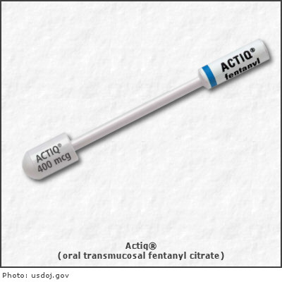 A white-colored oral transmucosal fentanyl citrate with a blue-colored cap. The cap has the brand name "ACTIQ" written on it in black letters. The label also has the number "400 mcg" written in smaller letters below it. The tip of the cap is long and thin and it appears to be made of plastic. The background is plain white.