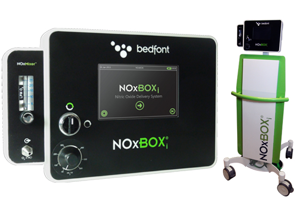 A black and white electronic device with the brand name "bedfont" written on it. The device is labeled "NOXBOX" and has a green and white color scheme. It has a control panel on the front with various buttons and knobs for adjusting the volume and other settings. On the right side of the device there is a small green cart with wheels which is used to store and transport the device. <br /><br />The device also has a small screen on the top right corner which displays the product's logo and a message that reads "NoxBox". This device is likely used for monitoring and controlling the device's settings.