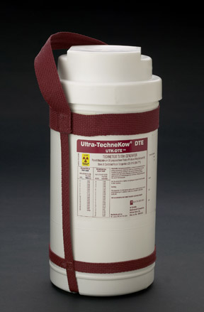 A white cylindrical container with a red strap attached to it. The container has a label on it that reads "Ultra-Technikow DTE" in bold black letters. Below the label there is a list of ingredients and nutritional information. The label also mentions that the container is made of stainless steel and has a capacity of 1 litre. The strap is secured to the container with two red straps. The background is black making the container stand out.