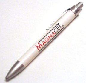 Of a silver-colored pen with the word "MAGNACET" written in red on the side. The pen has a sleek and modern design with a pointed tip and a silver body. The word is written in a bold sans-serif font and is centered on the pen. The background is plain white making the pen stand out.