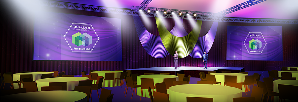 A large stage set up for a conference or event. The stage is decorated with purple and green lights and has a large screen on the left side with a logo of a cube on it. On the right side there are two large screens with the same logo. In the center of the stage there is a podium with two people standing on it facing each other. The podium is surrounded by rows of round tables with green tablecloths. The chairs are arranged in a semi-circle around the stage. The overall atmosphere of the event is elegant and professional.