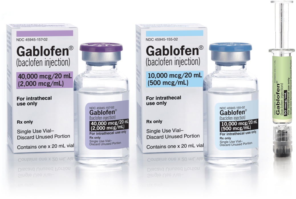 Three vials of Gablofen (baclofen injection) in different sizes and colors. The vials are arranged in front of a white box with the brand name and product name printed on it. The box is rectangular in shape and has a purple lid. Next to the vials there is a small syringe with a green liquid inside. The syringe is filled with a clear liquid and appears to be empty. The background is plain white.