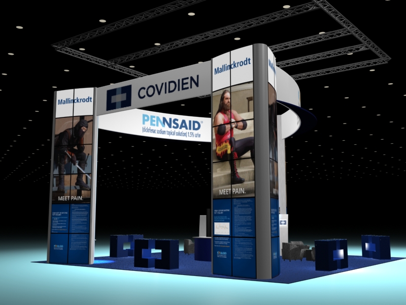 A trade show booth with a blue and white color scheme. The booth has a curved design with a large banner on the left side that reads "Covidien" and "Pennsaid" in bold letters. On the left side of the booth there is a Mallinckrodt advertisement featuring a person in a ninja outfit holding a sword. On the right side of the booth there is a Mallinckrodt advertisement of a man wearing a red and black wrestling outfit. Below the banner there are two smaller banners with the same text and images. The background is black and there are several blue cubes scattered around the booth representing tables. The overall design is modern and professional.