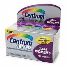 Of a box of Centrum Silver Ultra Women's tablets. The box is rectangular in shape and has a purple and white color scheme. The front of the box has the Centrum logo and the words "Ultra Women's" in bold white letters. Below the logo there is a description of the product which states that it supports breast and bone health. The label also mentions that the tablets are multivitamin-multimineral supplement and are 100 tablets in total. There is also a new label on the box that says "New". The box appears to be new and unused.