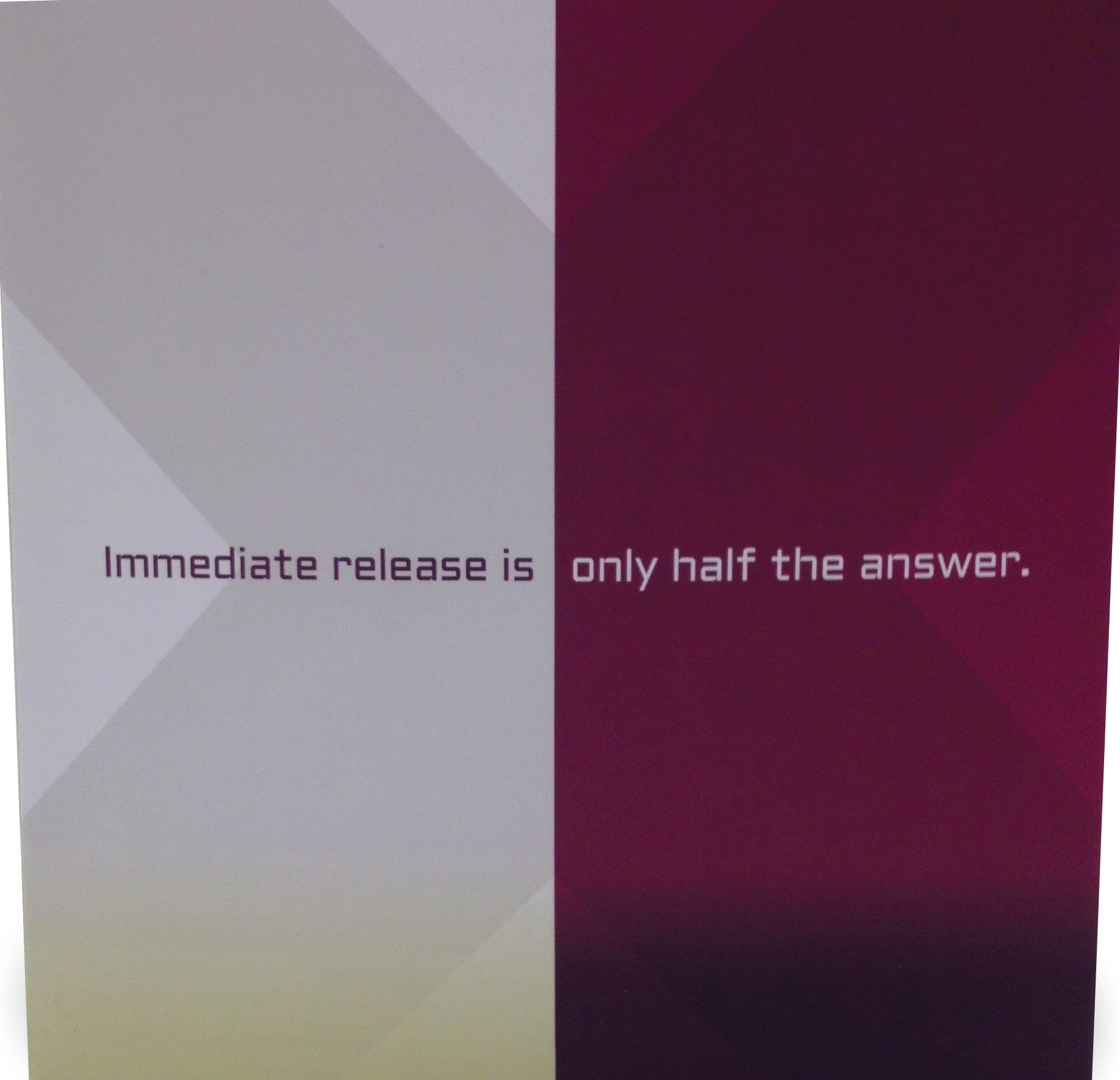 A graphic design with two panels. On the left panel there is a white background with a gradient effect. The top panel has a light grey color with a subtle gradient effect while the bottom panel is a darker maroon color. In the center of the image there are two lines of text that reads "Immediate release is only half the answer." The text is written in a bold sans-serif font and is centered on the panel. The overall design is simple and minimalistic.