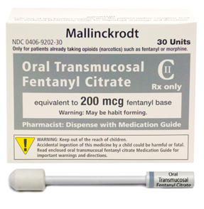 A product packaging of Mallinckrodt Oral Transmucosal Fentanyl Citrate. The packaging is a white box with a blue and yellow label on the front. The label has the brand name and product name written in bold black letters at the top. Below the label there is a warning message that reads "Only for patients already taking opioids (narcotics) such as fentanyl or morphine. Rx only. Equivalent to 200 mcg fentanyl base. Warning: May be habit forming. Pharmacist: Dispense with medication guide." <br /><br />At the bottom of the packaging there are two small syringes one with a white cap and the other with a yellow cap. The syringe is used to dispense the medication.