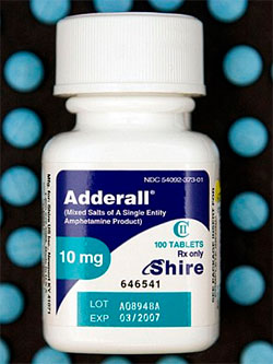 A photograph of a white medicine bottle with a blue label. The label has the brand name "Adderall" written in bold black letters at the top followed by the product name "Mixed Salts of A Single Entity" in smaller black letters. Below that there is a description of the product which states that it is 10 mg and 100 tablets. The bottle has a white cap and is placed on a black background with blue polka dots. At the bottom of the label it says "Lot A0894BA EXP 03/2007".