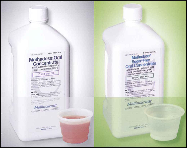 Two white plastic bottles of Methadose Oral Concentrate. The bottles are tall and cylindrical in shape with a white cap on top. The label on the bottles is blue and white with the product name "Methadose" written in bold letters. Below the label there is a description of the product which states that it is 10 mg per ml in size. <br /><br />In front of the bottles there are two small plastic cups one with a pink liquid inside and the other with a clear plastic lid. The cups appear to be empty. The background is a light green color.