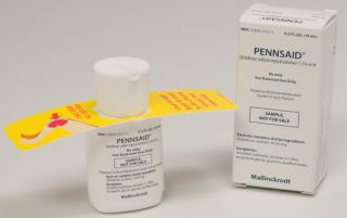 A white medicine bottle with a yellow label that reads "PENNSAID" and a white box with the same text. The bottle is cylindrical in shape with a white cap on top. The label also has an illustration of a red and yellow bird on it. The box is rectangular in shape and has the same design as the bottle. The text on the label is written in black and yellow and appears to be instructions on how to use the medicine. The background is plain white.