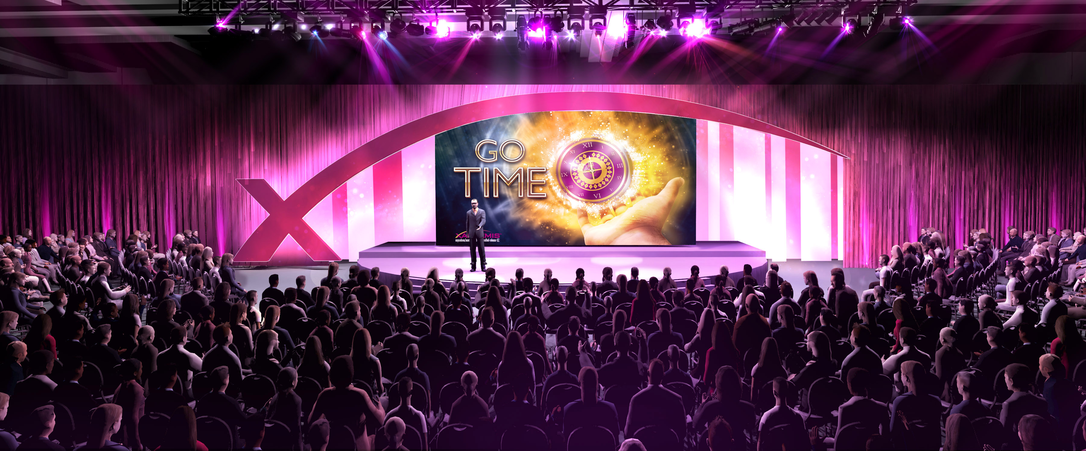 A large stage with a large screen in the center. The screen displays the words "Go Time" in bold colorful letters. The stage is decorated with pink and purple lights and there is a large X on the left side of the screen. The audience is seated in rows of chairs facing the stage with their hands raised in the air. The overall atmosphere of the image is one of excitement and anticipation.