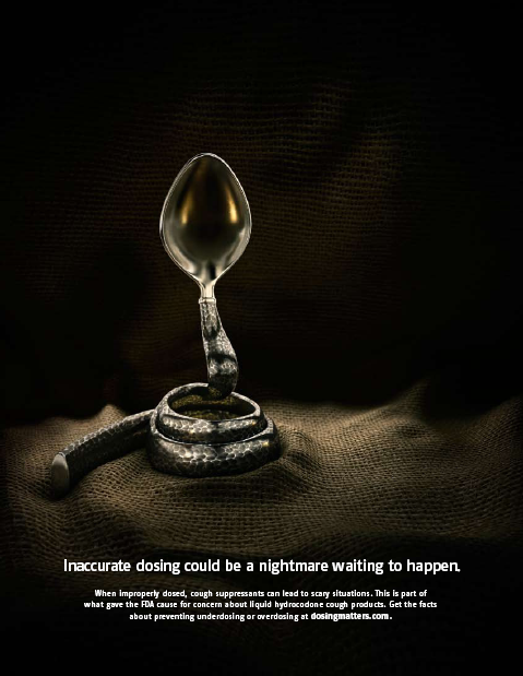 A digital art piece that features a spoon with a snake coiled around it. The spoon is made of silver and has a long handle with a round bowl at the end. The snake is coiled up on top of the spoon with its body facing towards the right side of the image. The background is black making the spoon and snake stand out. The text on the image reads "Inaccurate dosing could be a nightmare waiting to happen." The text is written in white and is in a modern sans-serif font. The overall tone of the piece is dark and ominous conveying a sense of danger and urgency.