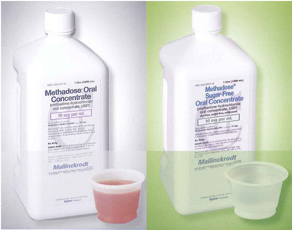 Two bottles of Methadose Oral Concentrate. The bottles are white with a blue label and a white cap. The label has the brand name "Methadose" written in bold black letters at the top. Below that there is a description of the product which states that it is 10 mg per ml in size. <br /><br />In front of the bottles there are two small plastic cups one with a pink liquid inside and the other with a white liquid inside. The cups appear to be empty. The background is a light green color.