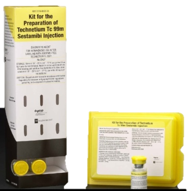 A kit for the preparation of Technetium TC 99m Sestambi injection. The kit is presented in a white cardboard box with a black label on the front. The label has the brand name "Tyco" written in bold black letters at the top. Below the label there is a description of the kit which states that it is a test tube with a yellow cap and a small vial with a white label. The vial is placed next to the box which is also yellow in color. The background of the image is black.