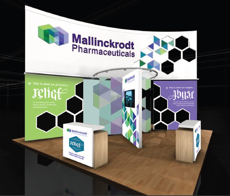 A trade show booth with a large banner that reads "Mallinckrodt Pharmaceuticals" in bold colorful letters. The banner is decorated with a geometric pattern of green blue and purple hexagons. Below the banner there is a green banner with the word "Relief" written in white letters. On the right side of the booth there are two smaller banners with the same text. The booth is set up on a wooden table with a black background.