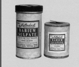 Two tins of Barium Sulfate. The tins are cylindrical in shape with a black lid on top. The label on the tins is white with black text that reads "BARIUM SULFATE" in large bold letters. Below the text there is a smaller text in smaller black letters that says "Made in the USA". The label also mentions that the product is made with natural ingredients and is suitable for use in a variety of applications.<br /><br />The tins appear to be old and worn with some of the labels showing signs of wear and tear. The background of the image is plain white.