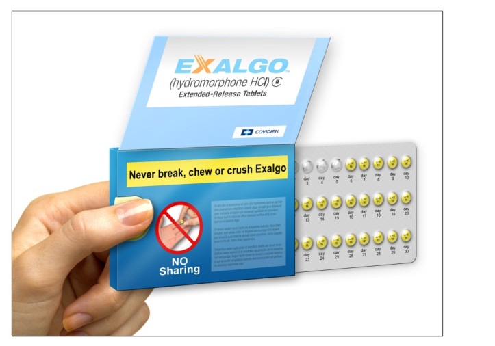 A hand holding a blue box of Exalgo (Hydromorphone HCI) extended-release tablets. The box has a white background with the brand name "Exalgo" written in bold blue letters at the top. Below that there is a red circle with a line through it that says "Never break chew or crush Exalgo". On the right side of the box there are 12 yellow pills arranged in a grid-like pattern. The pills appear to be new and unused. The text on the box reads "No Sharing".