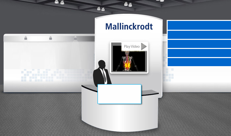 A modern exhibition stand with a white reception desk in the center. On the desk there is a silhouette of a man in a suit and tie standing in front of a large screen with the text "Mallinckrodt" and "Play Video" displayed on it. The background of the stand is white with blue squares on the left side. The stand appears to be in a large room with a high ceiling and gray walls.