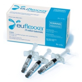 A blue and white box with the brand name "Euflexxa" and the product name "Ferring Pharmaceuticals" printed on it. The box is rectangular in shape and has a blue background. On the front of the box there is a label that reads "1% sodium hyaluronic acid" in white letters. Next to the label there are three syringes with clear plastic caps. The syringes are arranged in a row and appear to be new and unused.