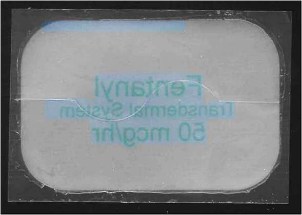 A photograph of a white rectangular object with a black border. The object appears to be made of plastic or a similar material and has a textured surface. The text on the object is written in blue and is in a cursive font. The background of the image is black making the white object stand out.