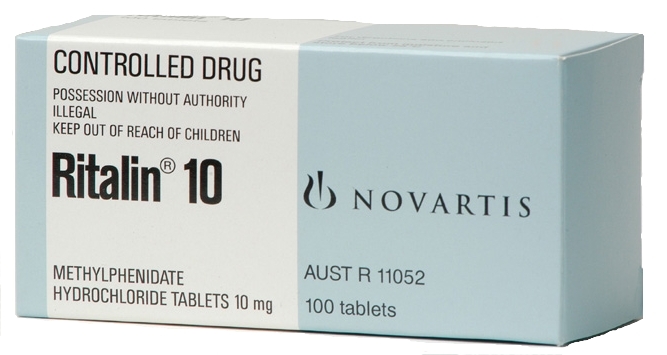 A photograph of a white box of Novartis Ritalin 10 tablets. The box is rectangular in shape and has a light blue background. The front of the box has the brand name "Novartis" written in bold black letters at the top followed by the product name "Controlled Drug" in smaller black letters. Below that there is a description of the product which states that it is "Possession without authority illegal keep out of reach of children" and "Methylphenidate Hydrochloride Tablets 10 mg". The box also mentions that the tablets are 100 tablets.