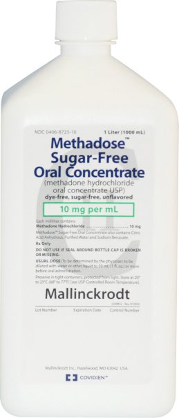 Of a white plastic bottle with a blue label. The label reads "Methadose Sugar-Free Oral Concentrate" in bold black letters. Below the label there is a description of the product which states that it is 10 mg per ml in size. The bottle has a capacity of 1000 ml. The brand name "Mallinckrodt" is written in smaller black letters at the bottom of the label.