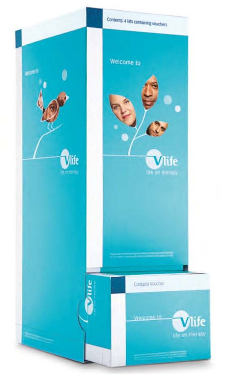 A blue cardboard box with a white background. The box is rectangular in shape and has a flat top. On the front of the box there is a blue banner with the word "Vlife" written in white letters. Below the banner there are three images of different facial expressions - a man's face a woman's face with a smile and a person's face. The text on the banner reads "Welcome to" and "Contains Voucher". The box also has a small logo of the company "Life" on the bottom right corner. The overall design is simple and modern with a clean and minimalistic look.