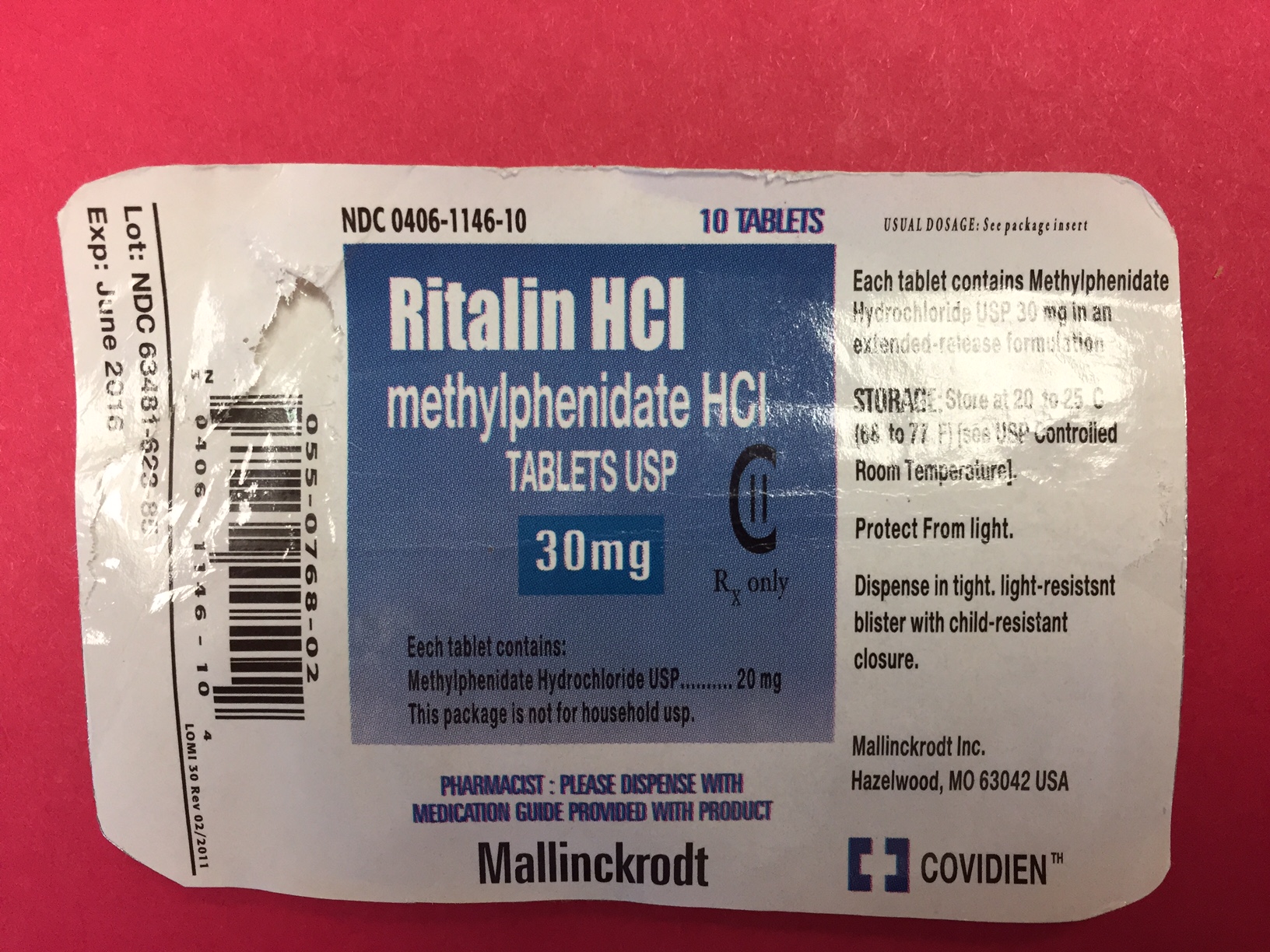 A photograph of a blister pack of Ritalin HCI methylphenidate HCI tablets. The blister pack is white with blue text and a barcode on the left side. The text on the blister pack reads "NDC 0406-1146-10" and "10 Tablets". Below the text there is a description of the product which states that it contains 30mg of the tablets. <br /><br />On the right side of the blister there are instructions on how to use the product. The instructions include:<br /><br />- Each tablet contains Methylphenidine HCI which is a type of medication used in the pharmaceutical industry.<br />- Protect from light dispense in tight light-resistant blister with child-resistant closure.<br /><br />At the bottom right corner of the image the brand name "Mallinckrodt" is written in bold letters and the product name "Covidien" is printed in smaller letters. The label also mentions that the product is available in the United States.