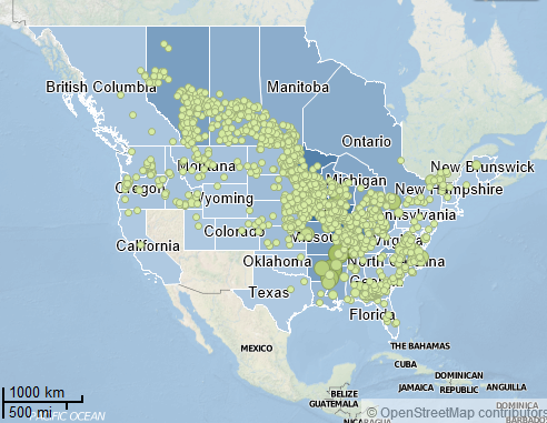 A map of North America. Many of the states in the United States and provinces in Canada are in different shades of blue. There are also green dots of different sizes scattered throughout the map. There is no key to indicate what the shades of blue or green dots represent. A footer indicates that the map was created in OpenStreetMap.