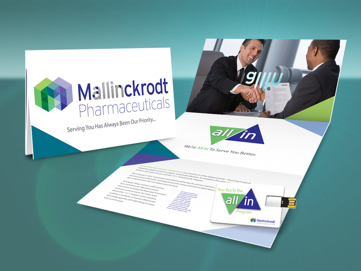 A brochure design for Mallinckrodt Pharmaceuticals. The brochure is divided into two sections. The left side of the brochure has a white background with the company's logo and text in blue and green colors. The logo is a hexagon with the letters "M" in the center and the text "Serving You Has Always Been Our Priority". The right side has a photo of two men shaking hands and smiling at each other. Below the photo there is text that reads "all in" in blue green and purple colors. <br /><br />The brochure also has a USB flash drive attached to it which is likely used to access the company website. The overall design is modern and professional with a clean and clean layout.