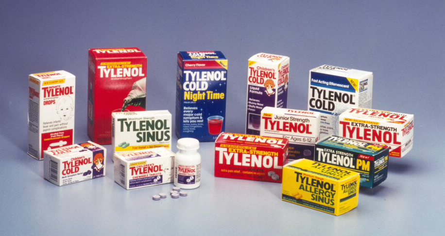 A collection of Tylenol products arranged in a scattered manner on a blue background. There are nine boxes of the product each with a different color and label. The boxes are of different sizes and shapes with some being red blue yellow green and white while others are yellow orange and red. There is also a small white bottle of the same product in the center of the image. The text on the boxes reads "Tylenol Cold Night Time" and "Sinus" in bold letters. The overall color scheme of the boxes is bright and vibrant with the red and blue boxes standing out against the blue background and the green and yellow boxes.