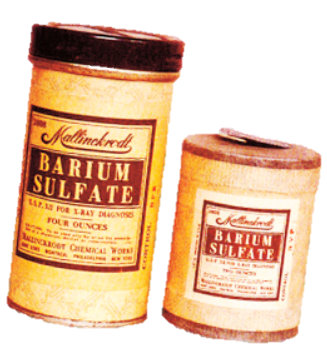 Two tins of Barium Sulfate. The tins are cylindrical in shape with a black lid and a yellow label on the front. The label has the brand name "Kellogg's" written in bold black letters at the top followed by the product name "Barium Sulfate" in smaller black letters. Below the label there is a description of the product which states that it is made with four ounces of barium sulfate and is suitable for use in various applications. The background of the image is white and the tins appear to be standing upright on a green background.