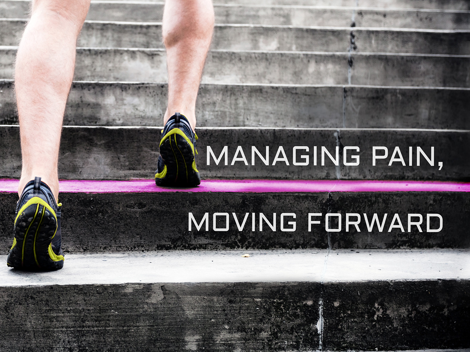 A person's legs and feet walking up a set of stairs. The person is wearing black and yellow running shoes with black soles. The stairs are made of concrete and have a pink line running down the middle. The background is blurred but it appears to be an outdoor setting with trees and greenery. Overlaid on the image is text that reads "Managing pain moving forward."