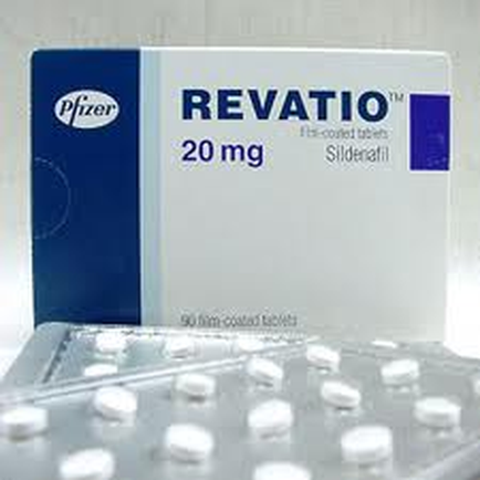A blue and white box of Pfizer relation 20 mg tablets. The box is rectangular in shape and has the Pfizer logo on the top left corner. The front of the box has the brand name "relation" written in bold white letters followed by the product name "20 mg" in smaller white letters. Below the brand's name there is a description of the tablets which reads "Sildenafil". The box also has a picture of a blister pack of white pills on it. The background is blurred but it appears to be a white surface.