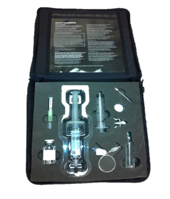 A set of medical equipment in a black case. The case is open revealing the contents inside. On the left side of the case there is a syringe with a needle and a cap and on the right side there are two other syringes one with a cap and the other with a handle. The syringe is made of clear plastic and has a transparent body with a silver cap. There is also a small bottle of liquid next to the syringe. The background of the image is black and there is text on the case that appears to be instructions or information about the equipment.